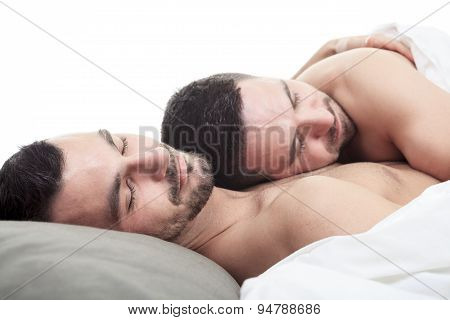 A homosexual couple onder a bed in studio white