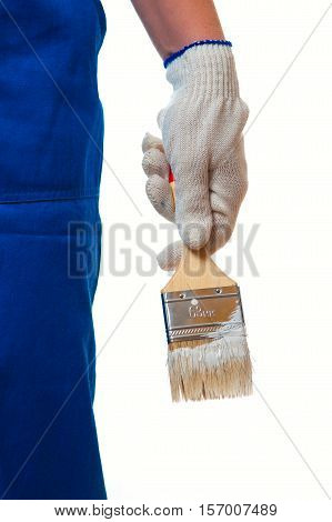 Cropped shot of housepainter in coveralls holding paintbrush with white color.