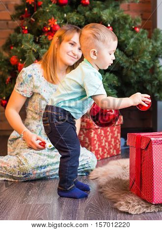 beautiful happy little boy with christmas balls.