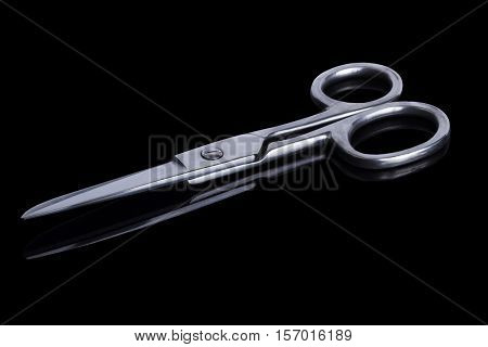 Stainless steel scissors on a black background