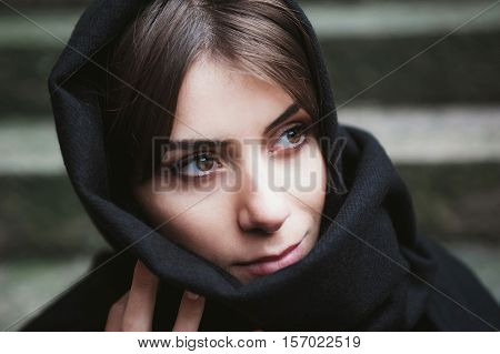 Young woman with headscarf, veiled, looking side.