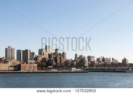 Manhattan skyline with river and clear blue sky