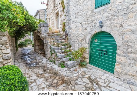 Small narrow street in Tucepi village in the slope of a mountain Biokovo.