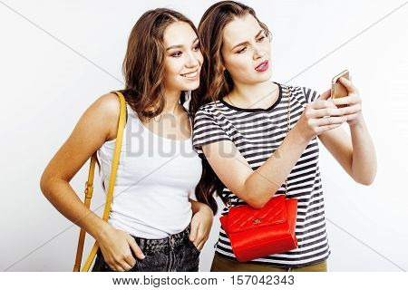 two best friends teenage girls together having fun, posing emotional on white background, besties happy smiling, making selfie, lifestyle people concept close up