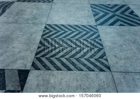 a big grey background squares with geometric pattern
