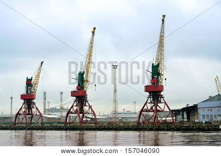 crane in the port red yellow green work