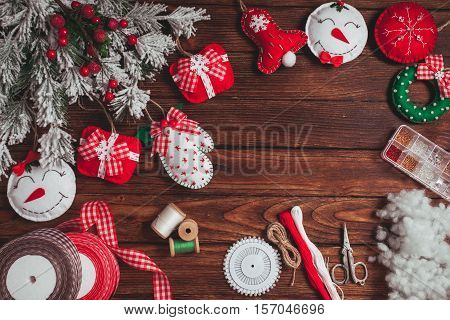 felt Christmas decorations on the wooden table - preparing for handmade