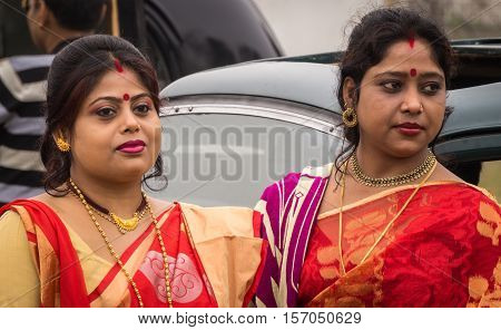 KOLKATA, INDIA - JANUARY 31, 2016: Indian married women dressed in traditional bengali outfits at the Statesman Vintage Car rally at the Fort William, Kolkata.