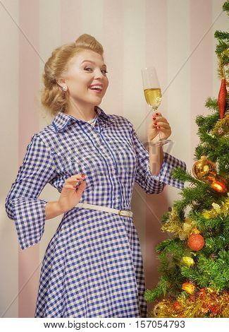portrait of nice young woman hanging around christmas tree on x-mas  eve