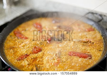 Paella cooking on an electric stove. Typical cuisine of the Valencian Community in Spain