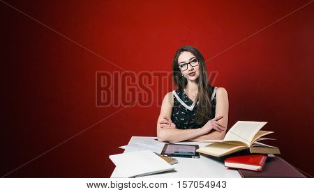Young attractive brunette girl in glasses looks to camera