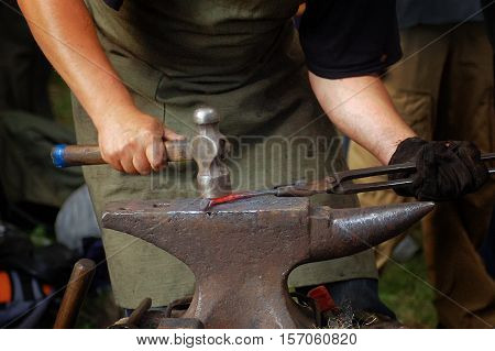 The hands of a blacksmith at work in the smithy