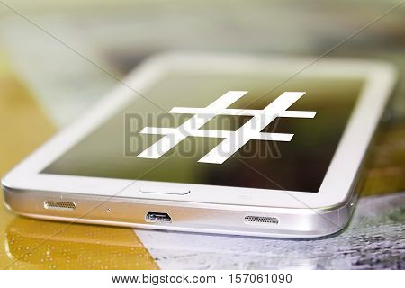 The symbol hashtag on the cell phone screen .