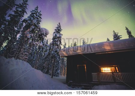 Beautiful scandinavian Finnish swedish norwegian wooden cottage cabin near slopes on a ski resort in the night time