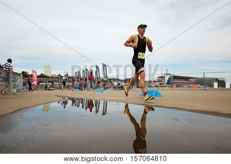 MOSCOW, RUSSIA - AUG 14, 2016: Participants of cross-country stage of traditional 3Grom series triathlon contest at Krylatskoye Rowing Channel sports complex.