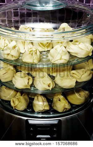 Healthy food in steamer, steam cooker with manti (steam dumplings)