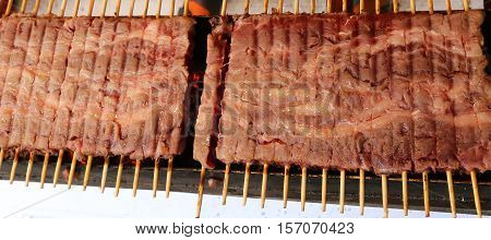 Many Meat Skewers Of Lamb Cooked On The Grill In The Street