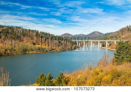 Colorful autumn landscape, bridge over Bajer Lake in Fuzine, Gorski kotar, Croatia