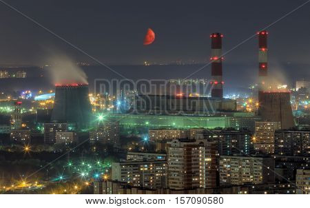 Territory of power plant and residential aera at summer moon night in Moscow, Russia