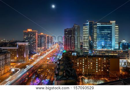New Arbat Street, highway with moving cars at moony night in Moscow, Russia
