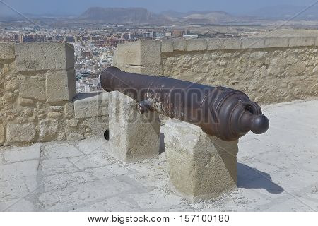 foreground of an ancient cannon in rampart of a fortress