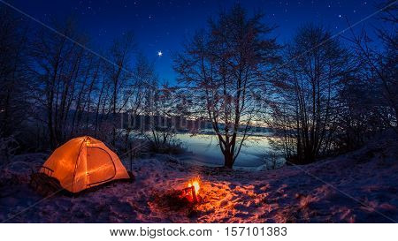 Illuminated Tent In The Winter Camp By The Lake At Night