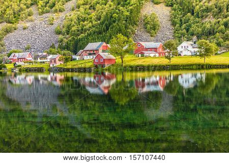 Norwegian Country Houses In The Mountains On Lake Shore