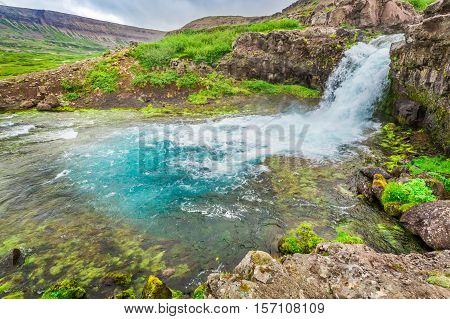 River Flows From A Waterfall In Iceland