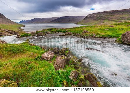 Mountain River Flowing Into The Lake Between The Mountains In Iceland