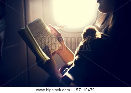 Woman Reading Writing Book Plane Concept