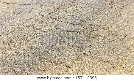 Cutting Of An Old Road With Cracked Asphalt And A Gully In The Center Of Cobblestones
