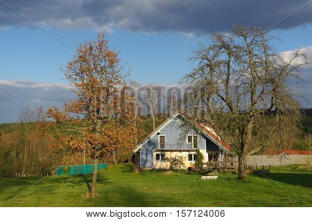 a german rural landscape with wooden house near spring forest. Black Forest in Baden Wuertemberg Schoemberg in Germany