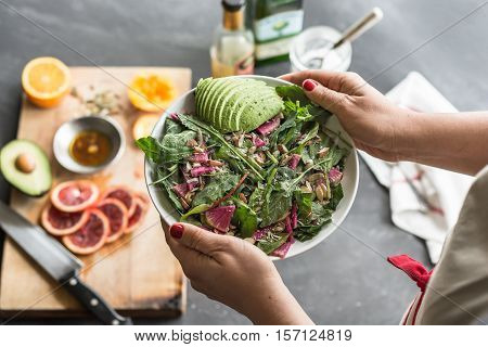 Serving a fresh organic mixed green salad
