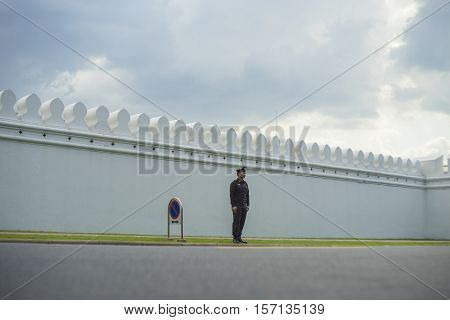 BANGKOK, THAILAND - OCT 15, 2016 : A police standing in front of The Grand Palace road.