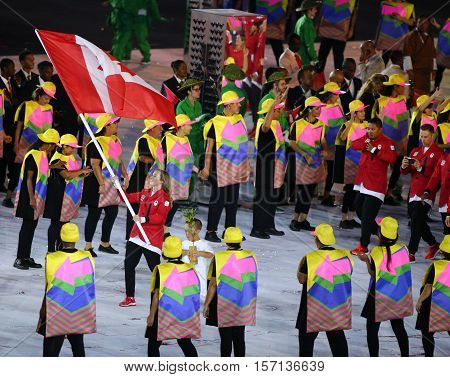 RIO DE JANEIRO, BRAZIL - AUGUST 5, 2016:Olympic champion trampoline gymnast Rosie MacLennan carrying Canadian flag leading the Olympic team Canada in the Rio 2016 Opening Ceremony at Maracana Stadium