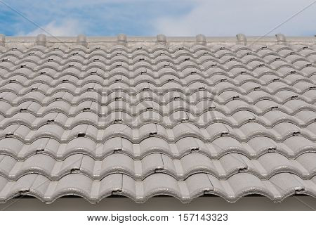 Rows of roof tiles on the top of house with sky background.