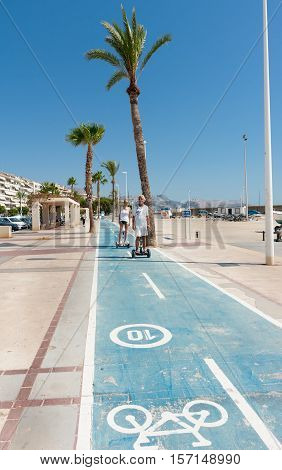 Altea, Spain - September 7, 2016; Segway riders on esplanade cycle-way along waterfront in Altea Spain.