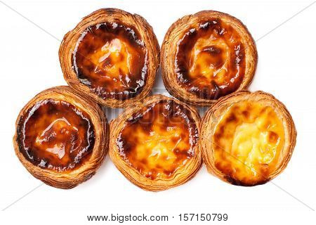 Egg Tarts isolated on white background. Heap of Typical portuguese dessert pasteis de nata close up