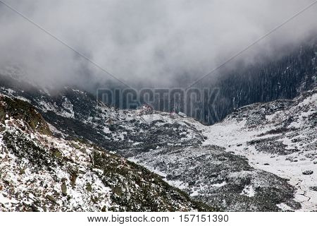 view on foggy valley in winter from Rodna Mountains in Transylvania - Romania