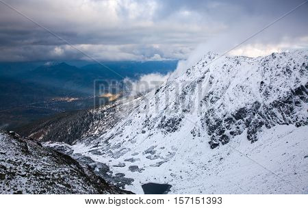 view on foggy valley in winter from Rodna Mountains in Transylvania - Romania