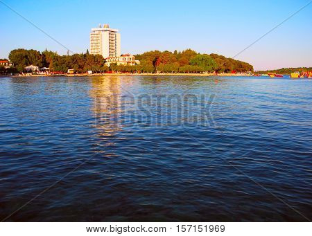 Beach with pines in Vodice in the sunset Croatia.