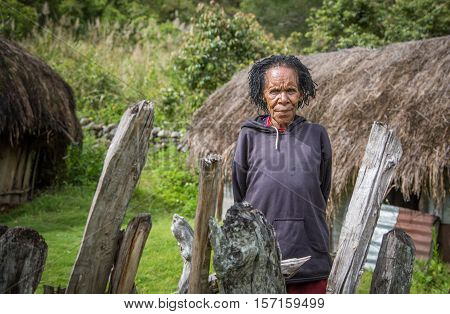 Wamena, West Papua, Inonesia - February 15th,  2016: dani tribe woman outside her home