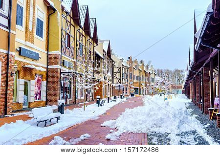 KIEV UKRAINE - NOVEMBER 11 2016: The Dutch style shopping city in snow looks like ready for Christmas fair on November 11 in Kiev.
