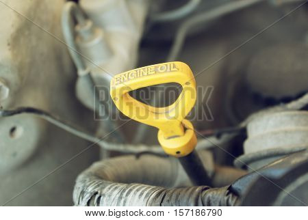 The oil dipstick of a car engine