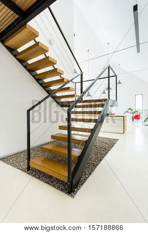 Wooden Staircase In White Kitchen
