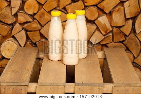 3 bottles of milk on a wooden stand
