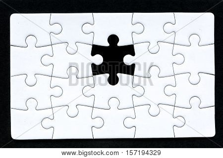 a puzzle that's missing one piece against a black background