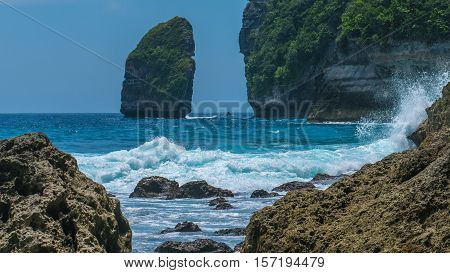 Rock in Tembeling Coastline at Nusa Penida island, Ocean Waves in Front. Bali Indonesia.