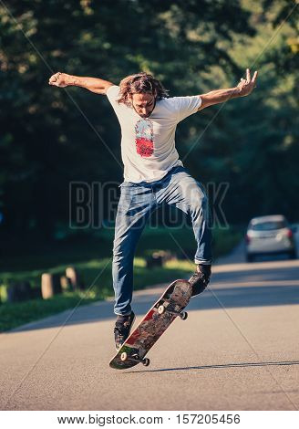 Action Shot Of A Skateboarder Skating, Doing Tricks And Jumping