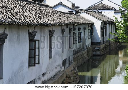 Weathered and old buildings lining the water canals in Luzhi Town in Jiangsu province China